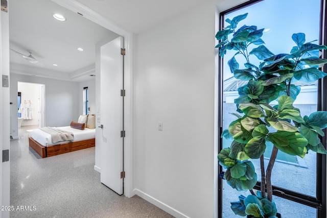 hallway with baseboards, recessed lighting, and speckled floor
