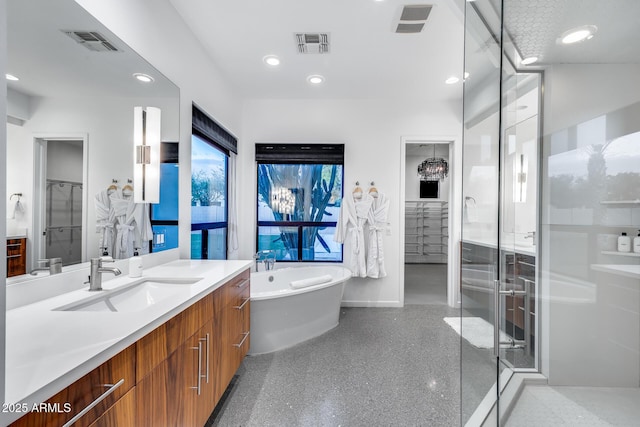 full bath with recessed lighting, visible vents, a freestanding bath, and vanity