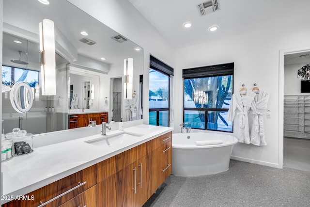 bathroom featuring baseboards, visible vents, and a soaking tub