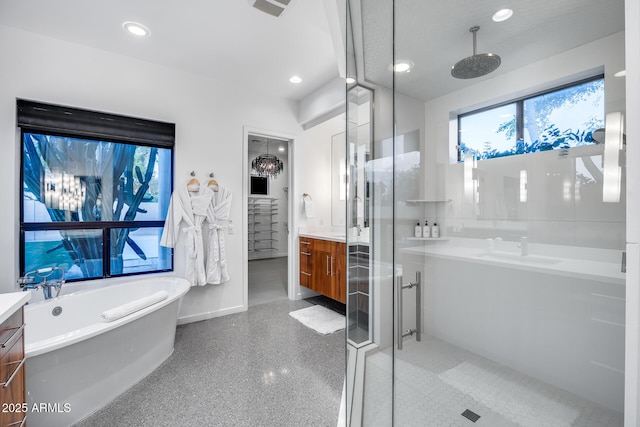 bathroom featuring vanity, recessed lighting, a freestanding tub, baseboards, and a shower stall