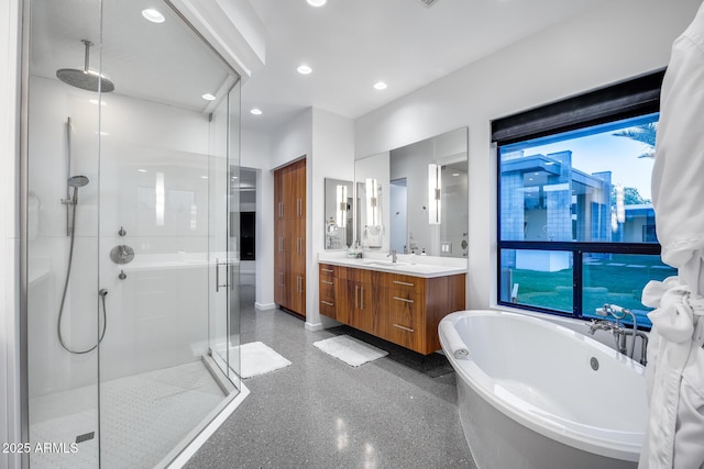bathroom featuring a freestanding tub, a shower stall, vanity, baseboards, and recessed lighting