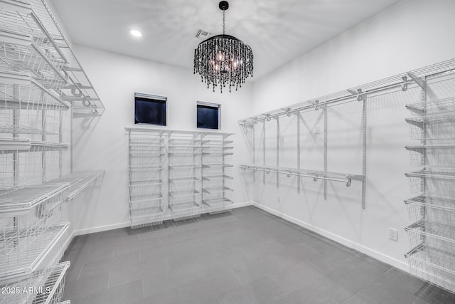 walk in closet with an inviting chandelier and visible vents