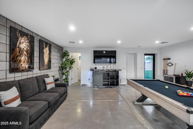 recreation room with finished concrete flooring, recessed lighting, and visible vents