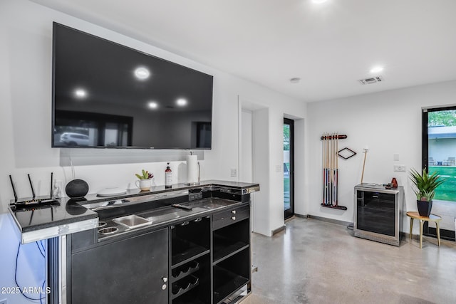 kitchen with visible vents, finished concrete flooring, dark countertops, open shelves, and dark cabinets