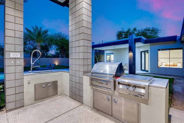 view of patio with grilling area, exterior kitchen, and a sink