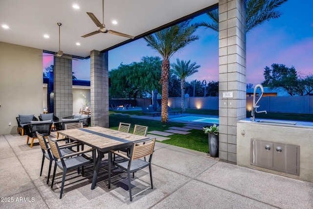view of patio with a fenced in pool, a ceiling fan, a fenced backyard, and outdoor dining area