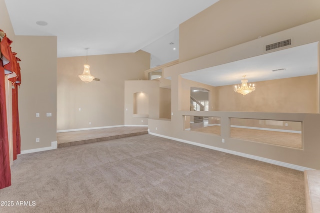 empty room with an inviting chandelier, carpet floors, high vaulted ceiling, baseboards, and visible vents