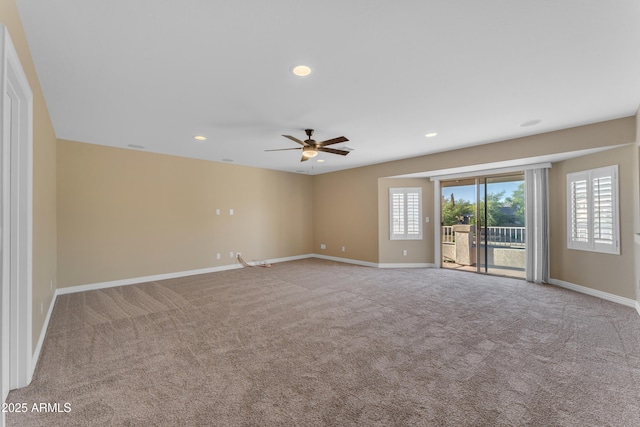 unfurnished room with baseboards, ceiling fan, and carpet floors