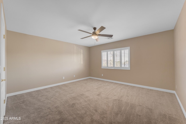 empty room featuring carpet floors, baseboards, ceiling fan, and visible vents