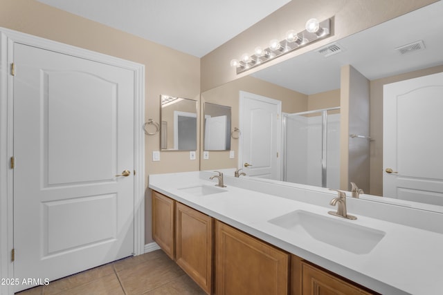 bathroom with a sink, tile patterned floors, and visible vents