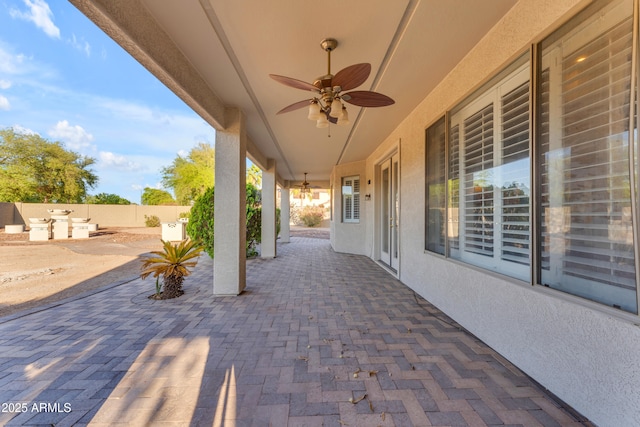 view of patio / terrace featuring an outdoor kitchen, ceiling fan, and fence