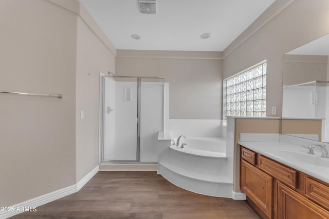 bathroom featuring vanity, wood finished floors, visible vents, a garden tub, and a stall shower