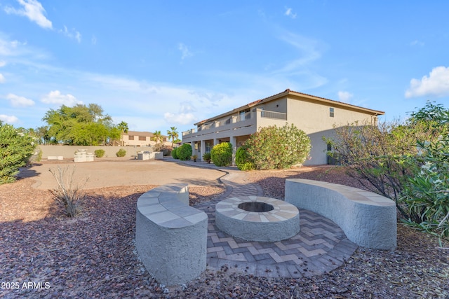 view of patio featuring fence and an outdoor fire pit