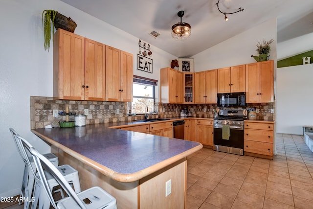 kitchen with lofted ceiling, light tile patterned floors, stainless steel appliances, a peninsula, and a sink