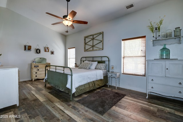 bedroom featuring ceiling fan, visible vents, baseboards, and dark wood finished floors