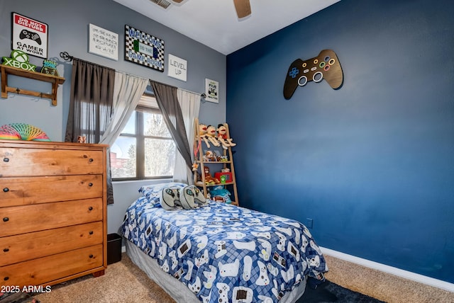 carpeted bedroom featuring ceiling fan, visible vents, and baseboards