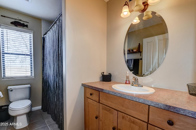 bathroom with vanity, tile patterned flooring, and toilet