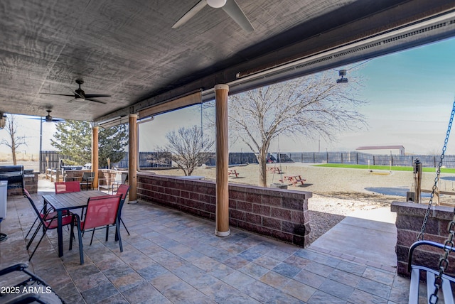 view of patio featuring ceiling fan, a fenced backyard, and outdoor dining area