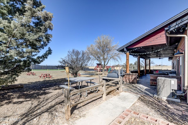 view of patio / terrace with fence and central air condition unit