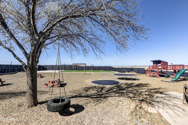 exterior space featuring playground community and fence