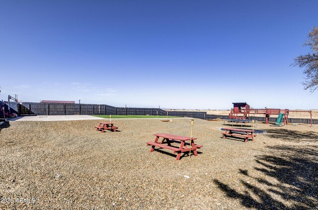 surrounding community featuring playground community and fence