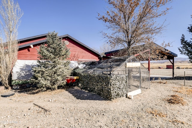 view of side of property with an outdoor structure