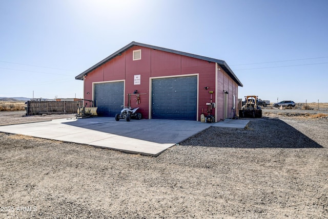 detached garage featuring fence