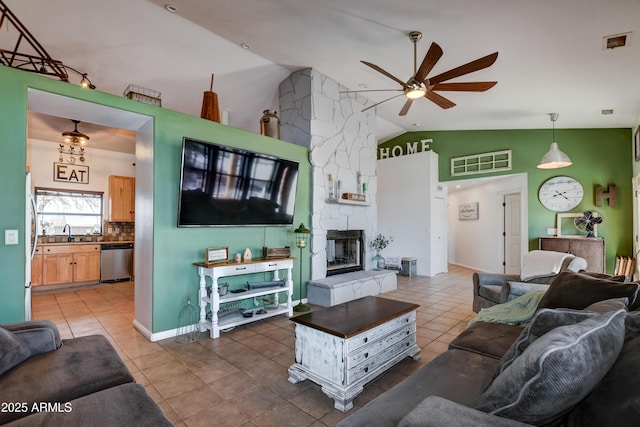 living room with visible vents, a ceiling fan, tile patterned flooring, a stone fireplace, and high vaulted ceiling