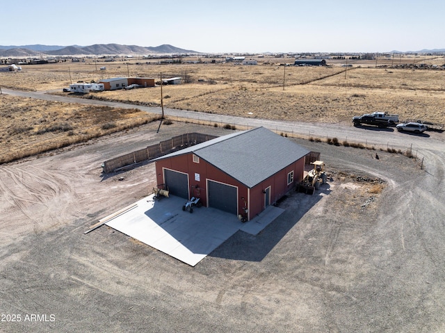 drone / aerial view featuring a mountain view and a rural view