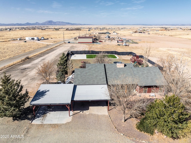 birds eye view of property featuring a rural view, a desert view, and a mountain view