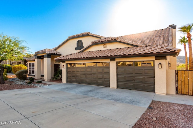 mediterranean / spanish-style home with a garage