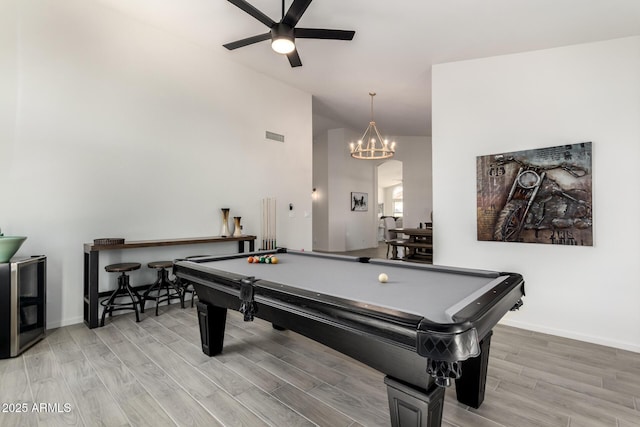 playroom featuring beverage cooler, light hardwood / wood-style floors, ceiling fan with notable chandelier, and pool table