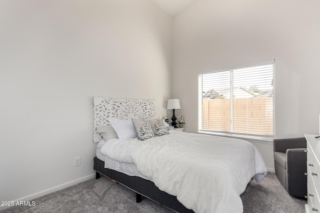 carpeted bedroom with lofted ceiling