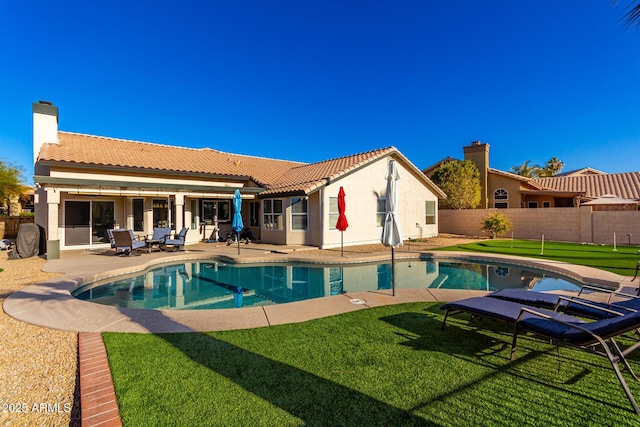 view of pool with a lawn and a patio area