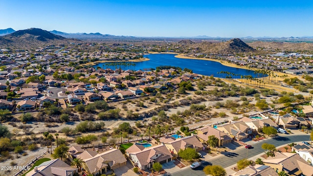 drone / aerial view featuring a water and mountain view