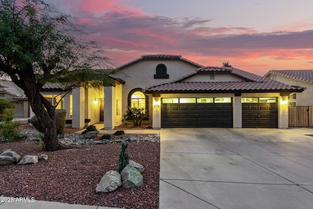 mediterranean / spanish house with a garage