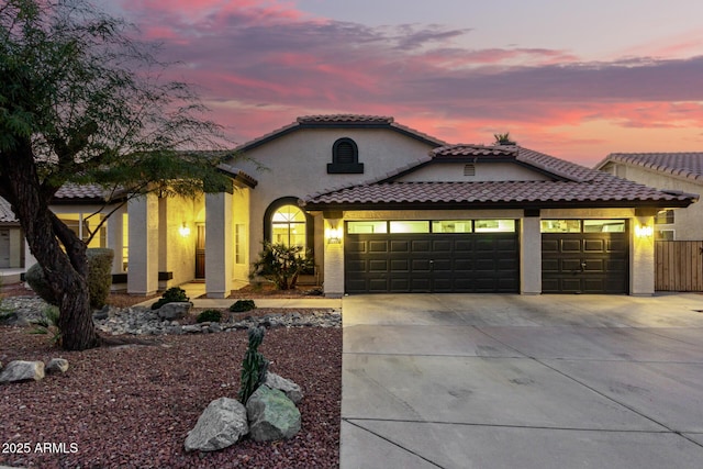 mediterranean / spanish house featuring a garage