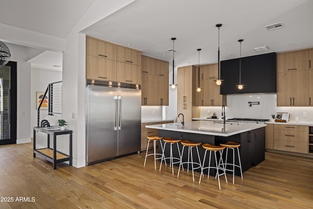 kitchen with modern cabinets, visible vents, and appliances with stainless steel finishes