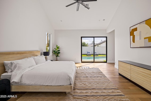 bedroom featuring high vaulted ceiling, access to outside, wood finished floors, baseboards, and ceiling fan