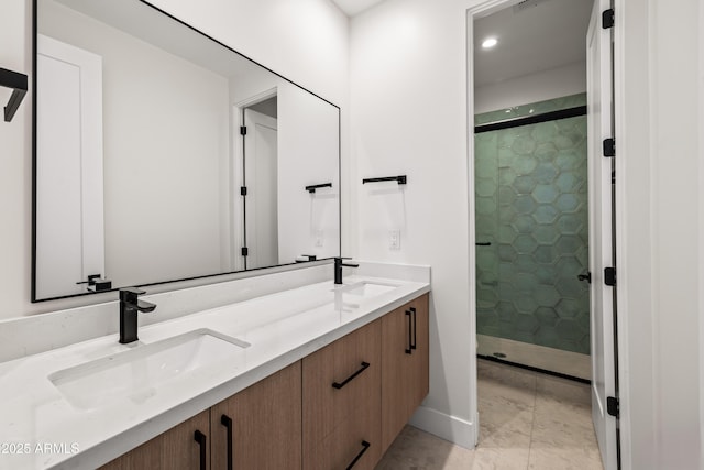 full bath with a sink, a stall shower, and double vanity