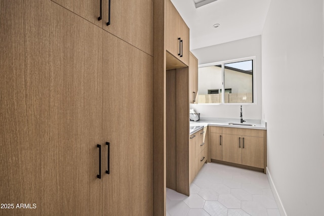 bathroom with tile patterned floors, vanity, and baseboards