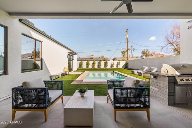 view of swimming pool with a patio, an outdoor kitchen, area for grilling, a fenced backyard, and an outdoor hangout area