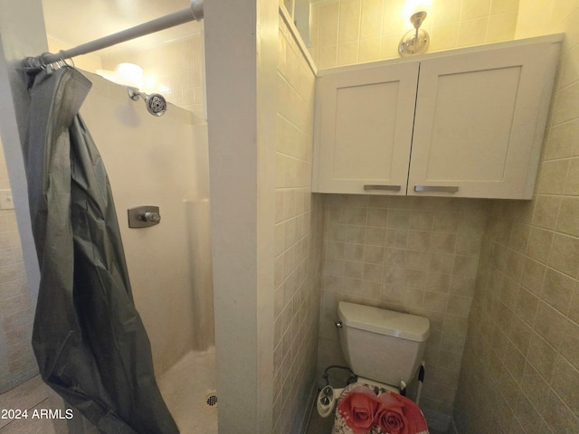 bathroom with walk in shower, tile walls, and toilet