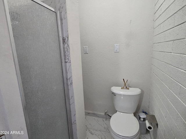 bathroom featuring toilet and an enclosed shower