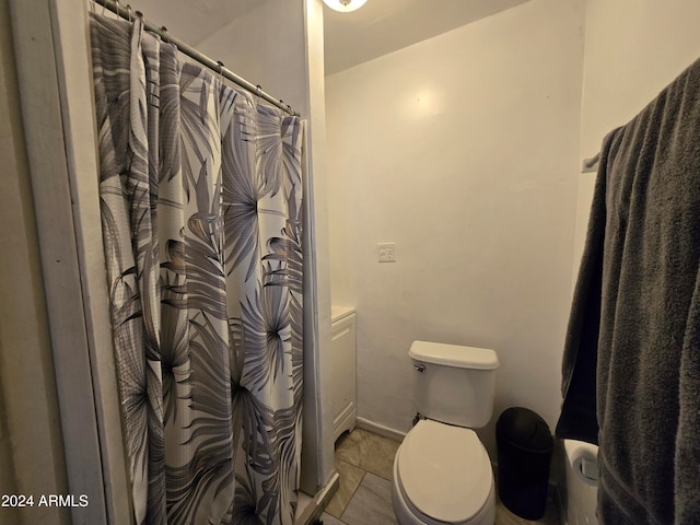 bathroom with vanity, curtained shower, tile patterned flooring, and toilet