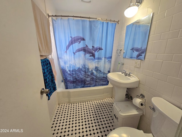 bathroom with toilet, tile walls, and shower / bath combination with curtain