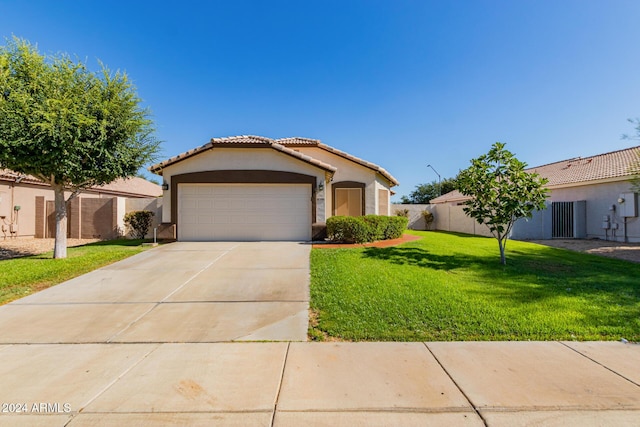 mediterranean / spanish-style home with a front yard and a garage