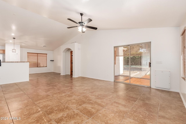 unfurnished living room featuring ceiling fan and vaulted ceiling