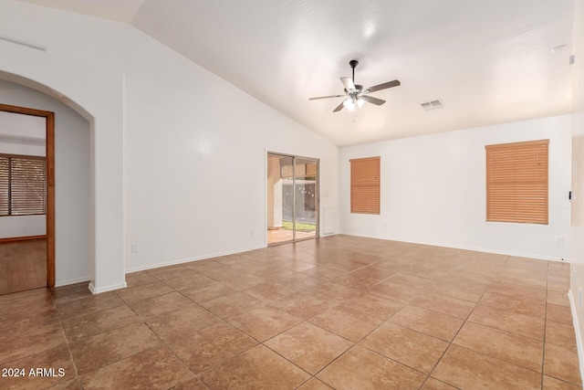 tiled empty room with ceiling fan and lofted ceiling