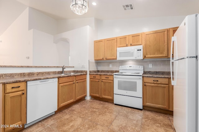 kitchen featuring decorative backsplash, white appliances, sink, and vaulted ceiling